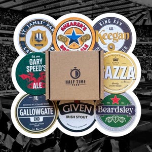May include: A set of 9 round coasters featuring images of Newcastle United Football Club players and logos. The coasters are made of cork and have a brown cardboard box with the text "Half Time Club".