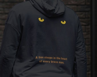 Sei furchtloser Löwenaugen-Hoodie: Tierliebhaber-Sweatshirt Pure Black, das Furchtlosigkeit und Entschlossenheit fördert - mit der Löwenzeichnung auf dem Baumwolloberteil