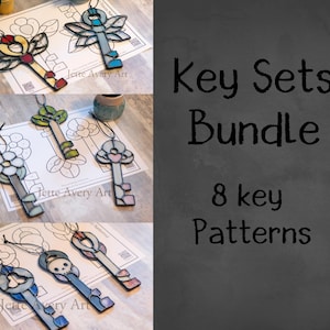 May include: A set of eight stained glass key patterns. The patterns are printed on white paper with the text "Jette Avery Art". The patterns include a dragonfly, a flower, a heart, and a skull.