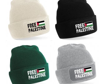 May include: Four knit beanies in different colors: beige, black, green, and gray. Each beanie has a patch with the Palestinian flag and the text "FREE PALESTINE" in white.