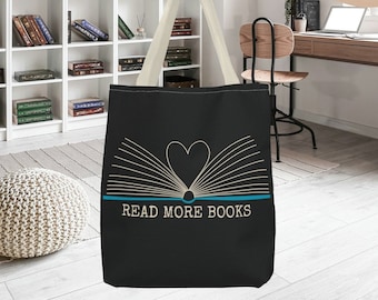 May include: Black tote bag with a white outline of an open book with a heart in the center. The text "READ MORE BOOKS" is printed in blue below the book.