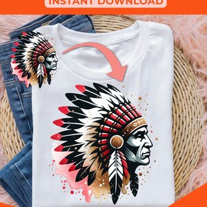 May include: A digital illustration of a Native American man wearing a headdress with feathers and a red and white design. The illustration is on a white t-shirt with a pink watercolor effect.