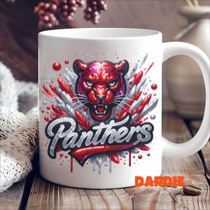 May include: White ceramic coffee mug with a red and silver graphic of a panther with the word "Panthers" in red and silver glitter.