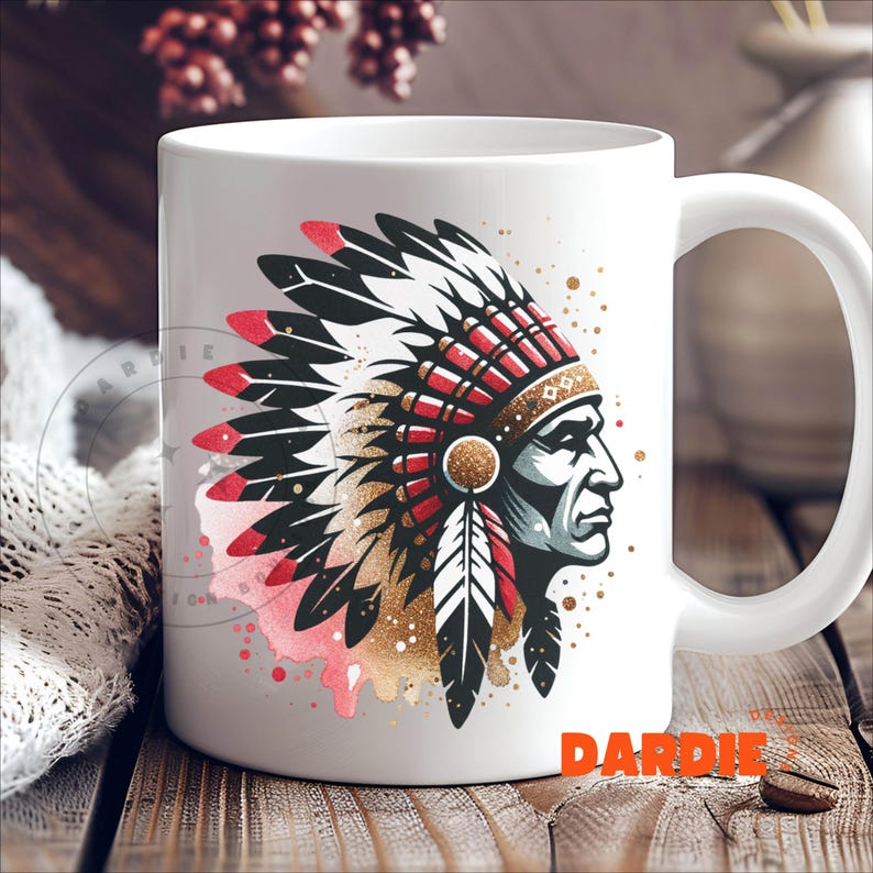 May include: White ceramic mug with a colorful illustration of a Native American chief wearing a headdress with red, white, and black feathers. The illustration is surrounded by gold glitter and pink watercolor splatters.