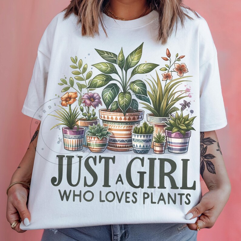 May include: White t-shirt featuring a graphic of potted plants and the text "Just a girl who loves plants".