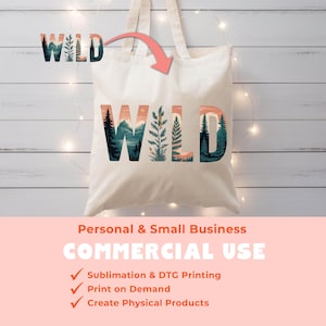 May include: A cream-colored tote bag with the word "WILD" in a nature-themed design. The letters feature mountain, forest, and plant illustrations in shades of green, orange, and blue. The bag has two handles and is displayed against a light wood background.