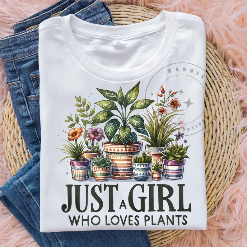 May include: White t-shirt featuring a graphic of potted plants and the text "Just a girl who loves plants".