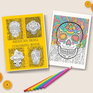 May include: A yellow colouring book titled MEXICAN SKULL COLORING BOOK with four skull illustrations on the cover, alongside a white page featuring a colourful skull drawing and a set of rainbow-coloured pencils arranged in a row below the items.
