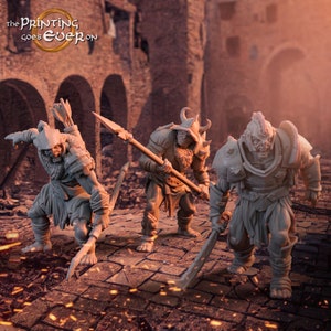 May include: Three unpainted plastic miniatures of orcs, each with a different weapon and pose. The orcs are wearing armor and have fierce expressions. The miniatures are set against a backdrop of a ruined city.