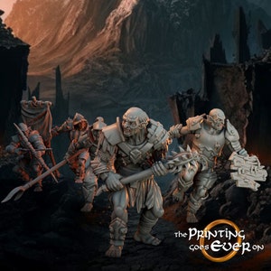 May include: A group of four grey plastic miniature figures of orcs, one holding a banner, one holding a sword, one holding a shield, and one holding a spiked club. The figures are posed in a battle stance. The background is a dark, rocky landscape.