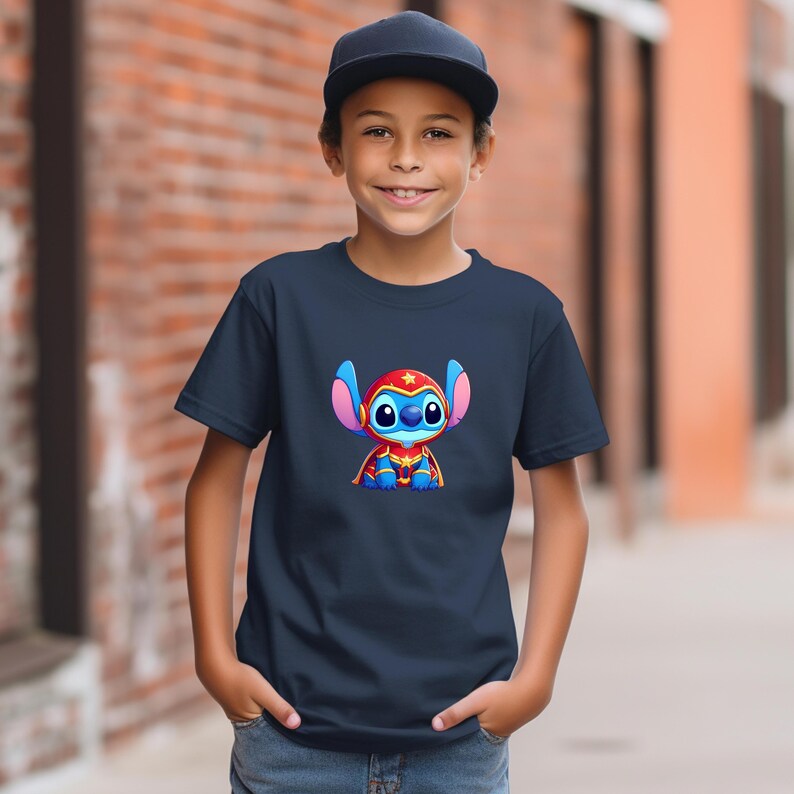 May include: Navy blue t-shirt featuring a cartoon character with blue skin, large ears, and a red superhero costume. The character has a star on its head and is sitting. The shirt is worn by a child.