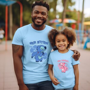May include: Light blue t-shirts with matching graphics. One shirt features the text "Her Stitch" with a blue cartoon character and a flower. The other shirt has "Her Angel" with a pink cartoon character and a heart.