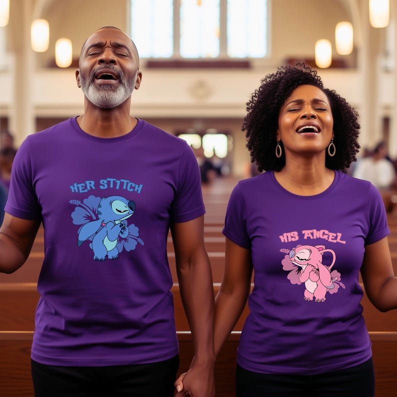May include: Two people wearing matching purple t-shirts. One shirt says "HER STITCH" with a blue cartoon character and the other says "HIS ANGEL" with a pink cartoon character. They are holding hands and singing.
