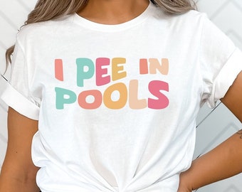 May include: White t-shirt with the text "I PEE IN POOLS" in colorful, stylized letters.