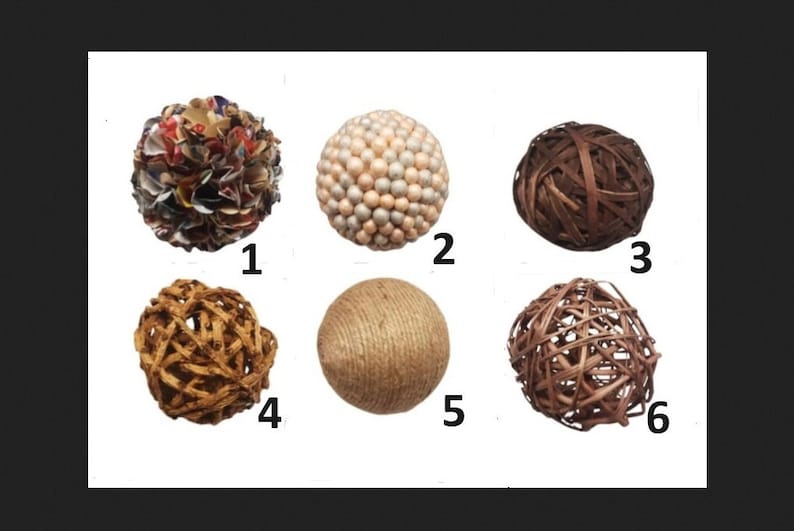 K&ouml;nnte beinhalten: Eine Sammlung von sechs dekorativen Kugeln. Die Kugeln bestehen aus verschiedenen Materialien, darunter geflochtenes Holz, Bindfaden und Stoff. Die Kugeln sind in verschiedenen Farben und Texturen erh&auml;ltlich, geeignet f&uuml;r die Inneneinrichtung.
