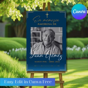 May include: A memorial sign on a wooden easel. The sign is dark blue with gold accents and features a photo of a man, the text "En memoria amorosa de Juan Gomez," and dates "MARZO 1946 - ABRIL 2025." The Canva logo is in the upper right corner.