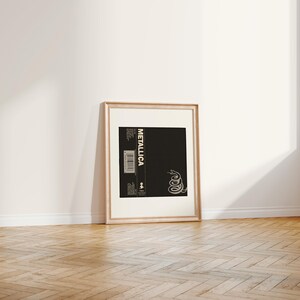 Close up of vintage Metallicas 1991 The Black album reproduction print  in an antique gold frame