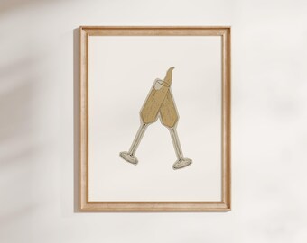 May include: A framed print featuring two champagne flutes clinking together. The flutes are filled with a bubbly liquid and have a light beige color. The frame is made of light-colored wood, and the background is off-white.