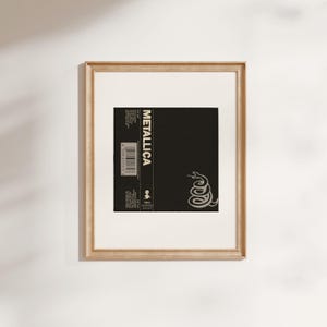 Close up of vintage Metallicas 1991 The Black album reproduction print  in an antique gold frame