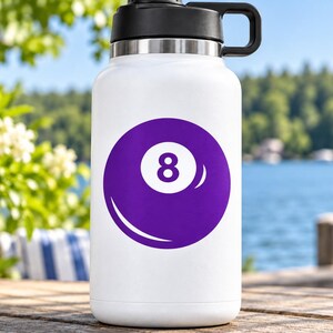 May include: A white insulated water bottle with a black lid and handle, featuring a large purple graphic of an eight ball with the number eight in white centered on the front of the bottle. The bottle has a smooth finish and a cylindrical shape.