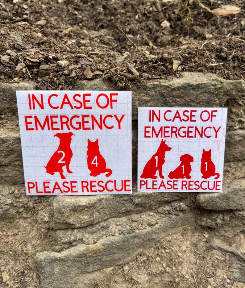 May include: Two white rectangular stickers with red text and dog silhouettes. The text reads "IN CASE OF EMERGENCY PLEASE RESCUE". One sticker shows two dogs with the numbers 2 and 4. The other shows three dogs with the numbers 1, 1, and 1.