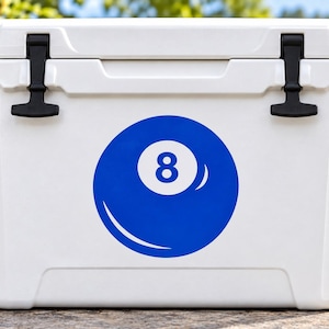 May include: A white rectangular cooler featuring a large blue circular graphic of an eight ball with the number eight centered in a white circle. The cooler has two black rubber latches on the top lid and a smooth, solid white exterior finish.