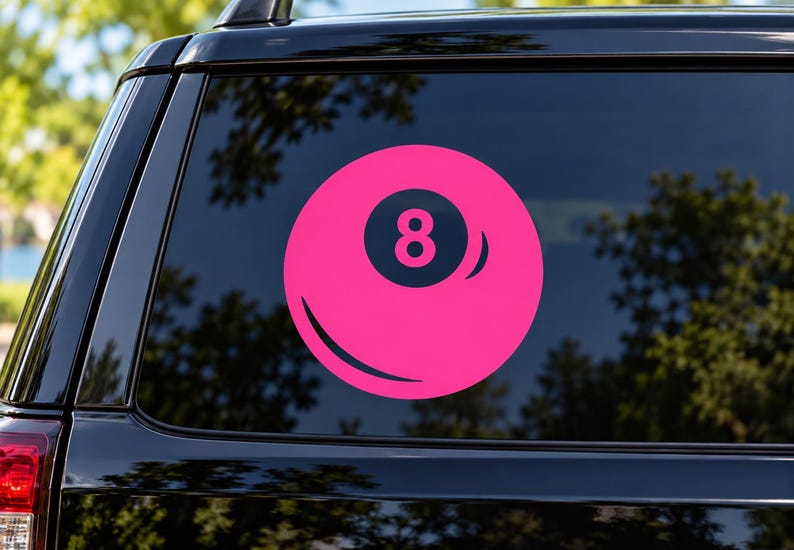 May include: A circular vinyl decal featuring a bright pink billiard ball design with a dark navy blue center circle containing the number eight in pink. The graphic includes a curved highlight line on the lower left and a curved shadow on the right.