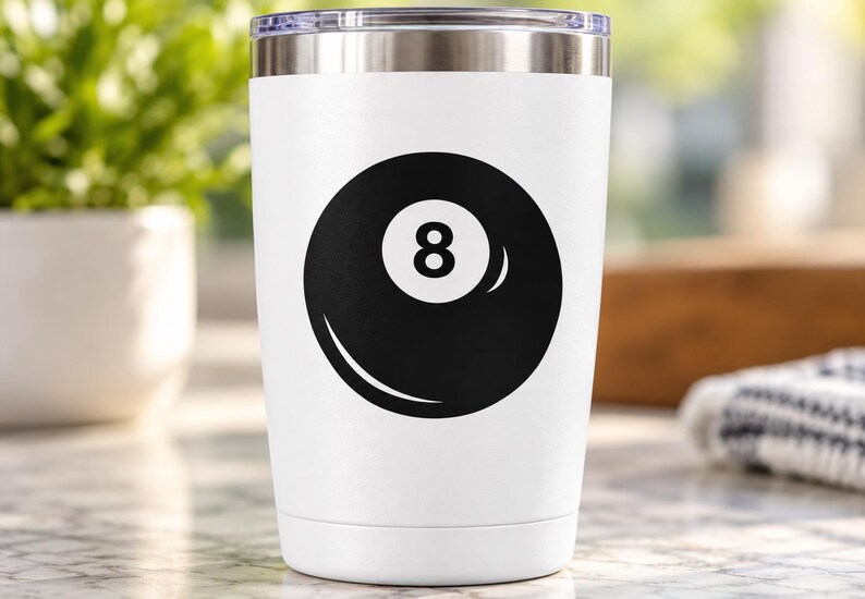 May include: A white stainless steel tumbler featuring a black graphic of an eight ball on the front. The drinkware has a tapered cylindrical shape with a metallic silver rim at the top and a clear lid, showcasing a clean and simple design.