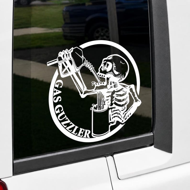 May include: A white vinyl decal featuring a skeleton holding a gas pump nozzle to its mouth and a mug in its other hand. The design is enclosed in a circular border with the text GAS GUZZLER printed along the left side in a bold font.