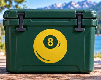 May include: A dark green rectangular cooler featuring a large yellow graphic of an eight ball on the front center. The cooler has a solid lid with two black rubber latches on the top corners and a smooth, durable exterior finish for storage.