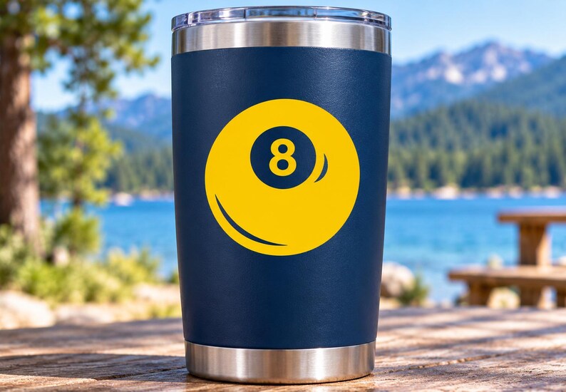 May include: A navy blue stainless steel tumbler featuring a yellow graphic of an eight ball with the number eight centered in a dark blue circle. The tumbler has a metallic silver rim at the top and a matching metallic silver base at the bottom.