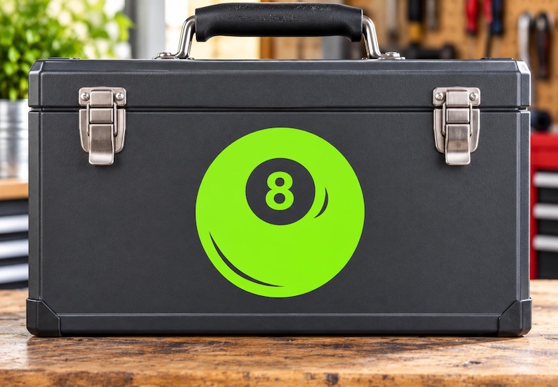May include: A matte black rectangular metal toolbox featuring a prominent lime green circular decal on the front. The decal displays a stylized black number eight inside a dark circle, mimicking the appearance of a billiard ball design.