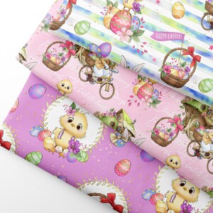 May include: Three folded pieces of fabric featuring Easter-themed patterns. One piece has blue and white stripes with bunnies on bicycles and baskets of eggs. Two pieces are solid pink with yellow chicks, colourful eggs, and bunnies.