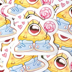 May include: A sticker featuring a cartoon character with a yellow triangle body, large eye, and a smiling mouth. The character wears light blue sneakers with baseball logos and holds a pink lollipop. Pink hearts are scattered around the character.