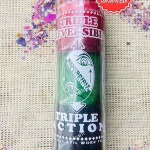 May include: A triple action candle with a red, green, and black wax design. The candle is labeled "Triple Reversible" and "Triple Action".