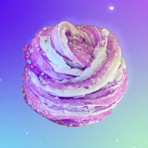 May include: A close-up of a swirl of purple and white slime with iridescent glitter. The slime is a vibrant mix of colors, with layers of purple and white creating a textured, abstract design. The background is a gradient of purple and blue.
