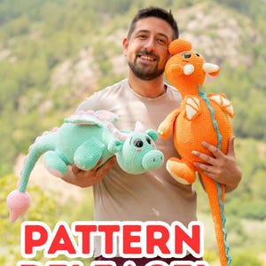 May include: Two crocheted dragon toys. One is light green with pink accents, the other is orange with blue accents. The toys are held by a person. The word "PATTERN" is visible in the image.