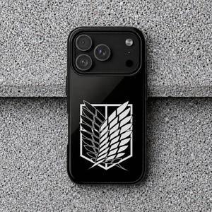 May include: A black smartphone case featuring a white graphic of the Wings of Freedom emblem from Attack on Titan. The case has a glossy finish and a cutout for the triple camera lens array located at the top left corner of the device back.