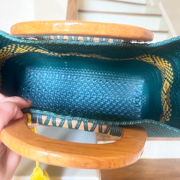 Green and yellow woven bag with wooden handle