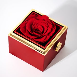 A real red preserved rose in a red and gold box, symbolizing eternal love and luxury with an engraved heart necklace for her