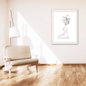 May include: A black and white line drawing of a person sitting with flowers growing out of their head.