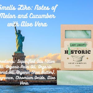 May include: A bar of green soap with a light green swirl, packaged in a cardboard box. The box is labeled "Lady Liberty Historic Soap Company." The image includes the Statue of Liberty and text that reads "Smells Like: Notes of Melon and Cucumber with Aloe Vera."