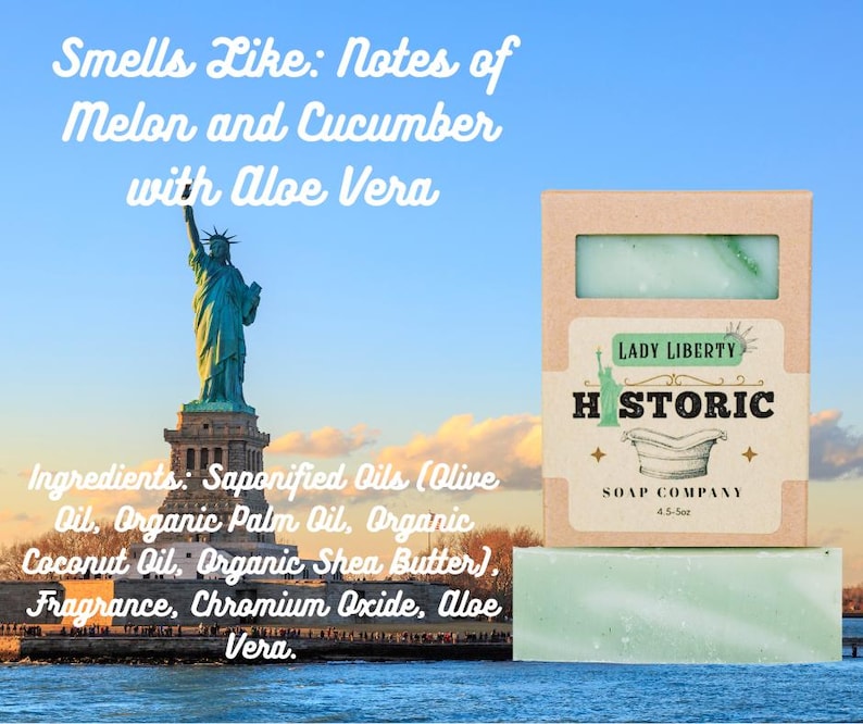 May include: A bar of green soap with a light green swirl, packaged in a cardboard box. The box is labeled "Lady Liberty Historic Soap Company." The image includes the Statue of Liberty and text that reads "Smells Like: Notes of Melon and Cucumber with Aloe Vera."