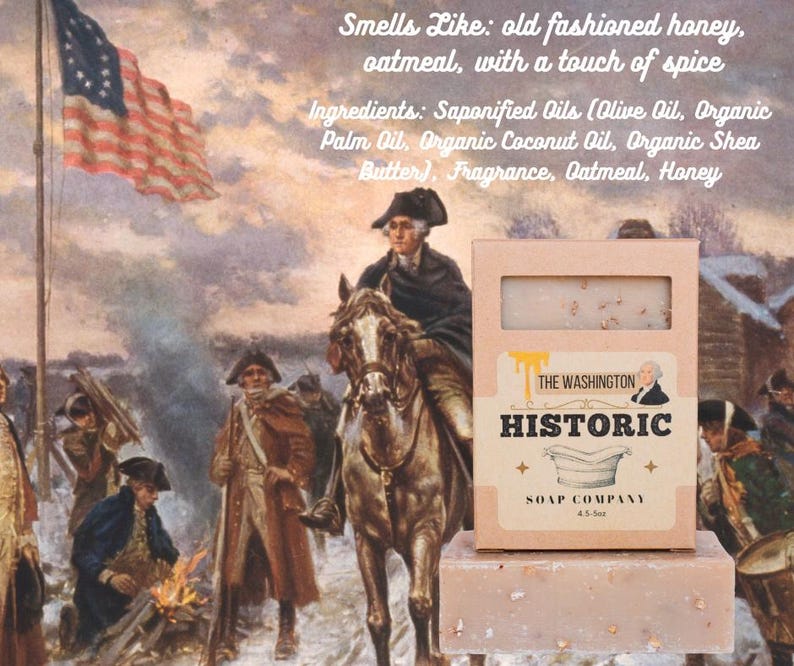 May include: A bar of soap and its box from The Washington Historic Soap Company. The box is light brown with the company name and a picture of George Washington. The soap is light brown and has a rectangular shape. The background is a painting of George Washington on a horse.