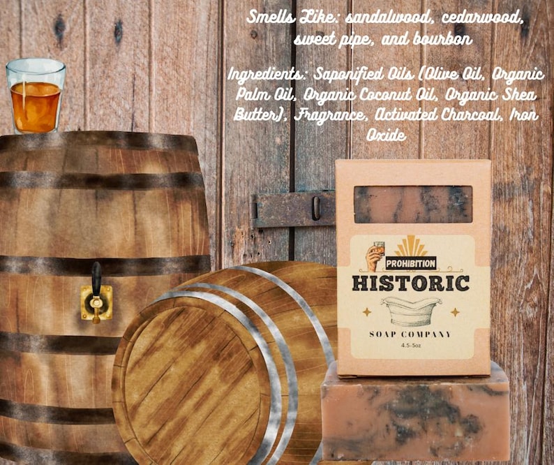 May include: A bar of soap and its packaging from the Prohibition Historic Soap Company. The packaging is tan with the company name and logo. The soap is brown with dark gray marbling. A glass of amber liquid sits atop a wooden barrel.