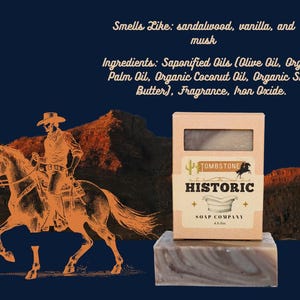 May include: A bar of soap and its box from the Tombstone Historic Soap Company. The box is tan with the company logo and the words "Historic Soap Company". The soap smells like sandalwood, vanilla, and musk.