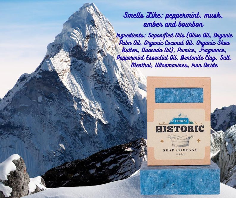 May include: A bar of blue soap and its box, with the text "Everest Historic Soap Company." The box is brown with a blue soap bar visible through a window. The background features a snowy mountain.