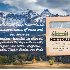 May include: A bar of soap in a cardboard box with the text "Historic Soap Company" and "The Rockies". The soap is light blue and the box has a mountain landscape background. The text on the box says the soap smells like crisp mountain air, musk, and frankincense.