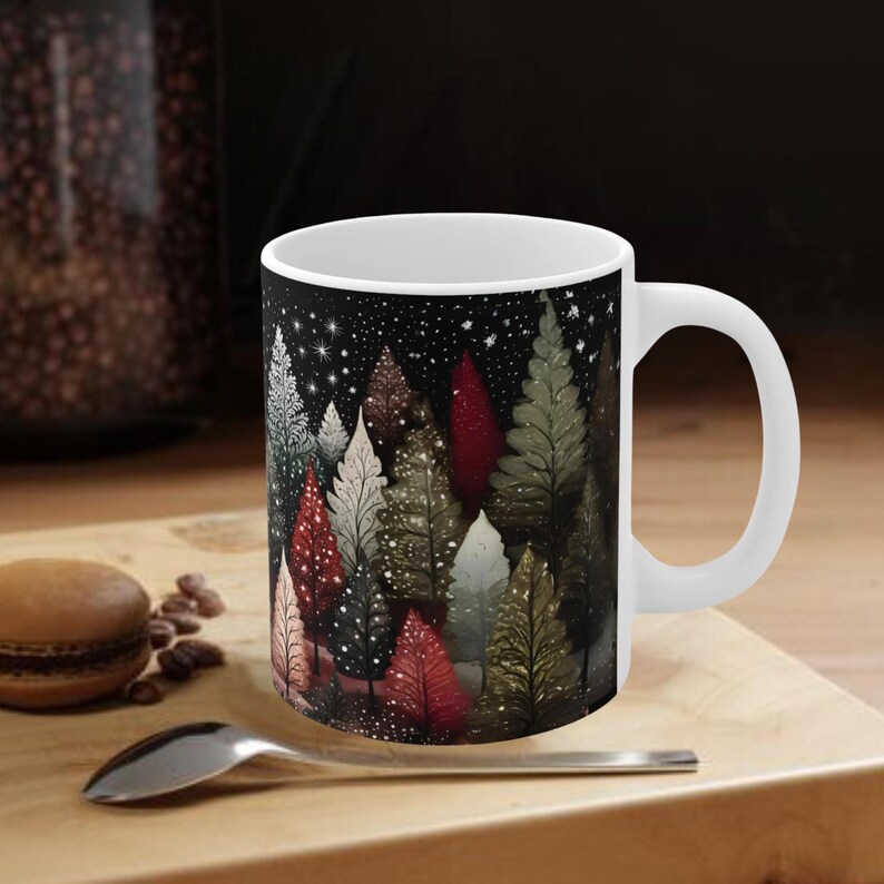 May include: White ceramic mug with a black background and a colorful illustration of a forest scene with trees and a starry night sky.