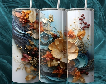 Op de afbeelding: Drie roestvrijstalen bekers met een bloemenontwerp. Het ontwerp bevat een verscheidenheid aan bloemen in tinten goud, oranje en blauw, met een achtergrond van blauwe en witte swirls.